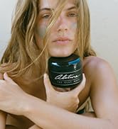 woman holding alitura clay mask anti aging soothing exfoliating skincare treatment organic