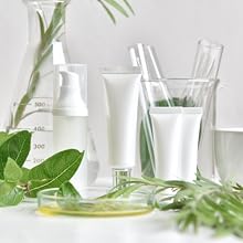 a set of generic skin care conatiners and green leaves and herbs