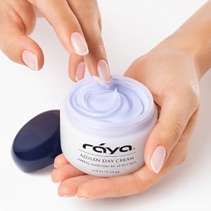 white hands holding a jar of moisturizer with one finger in the jar