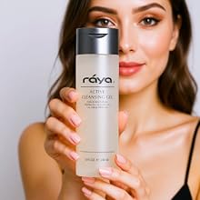a white woman holding a clear cleanser in a bottle